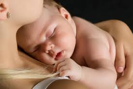 Child at rest in its mother's arms