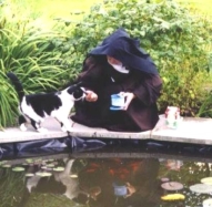 Feeding the fish in our monastery pond with the help of Sammy