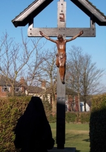Praying before crucifix in garden
